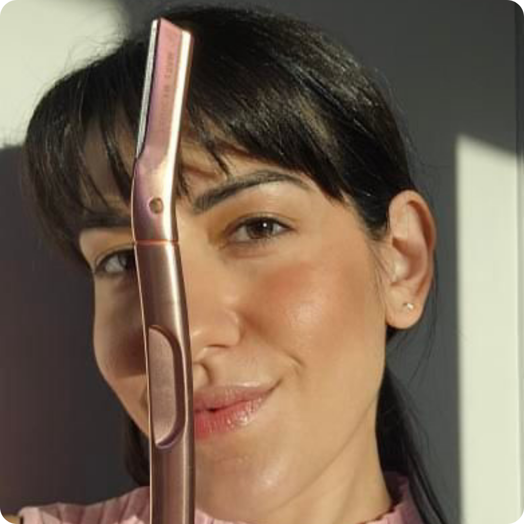 Woman holding a rose gold tool for dermaplaning Australia