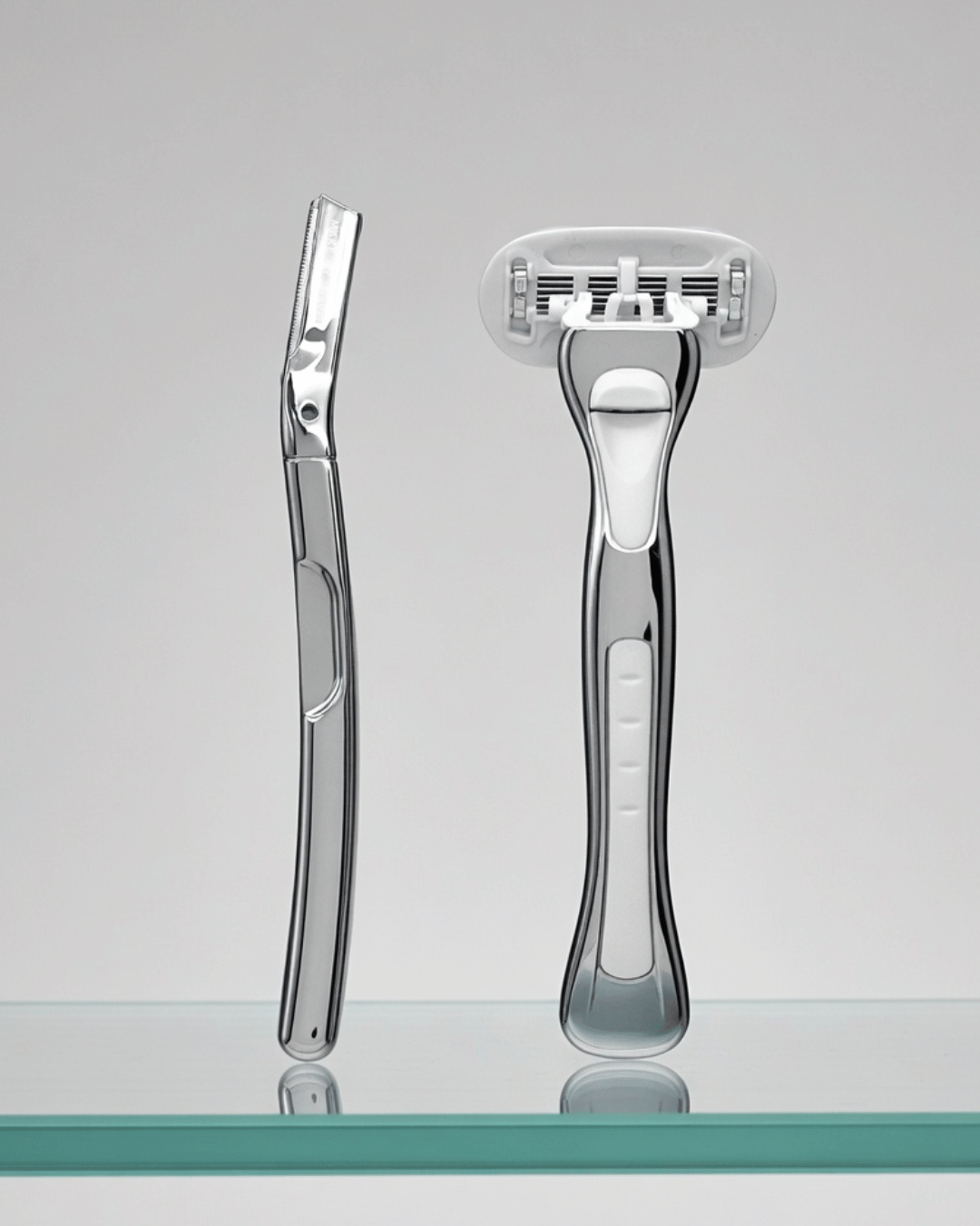 Women's razor Australia and Metal Dermaplaner by Make My Shave on a reflective surface with a grey background