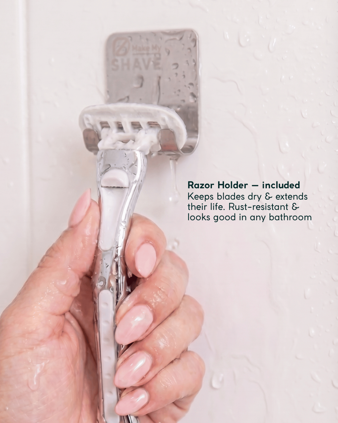 Hand holding Make My Shave women's razor with a razor holder attached, against a light background.