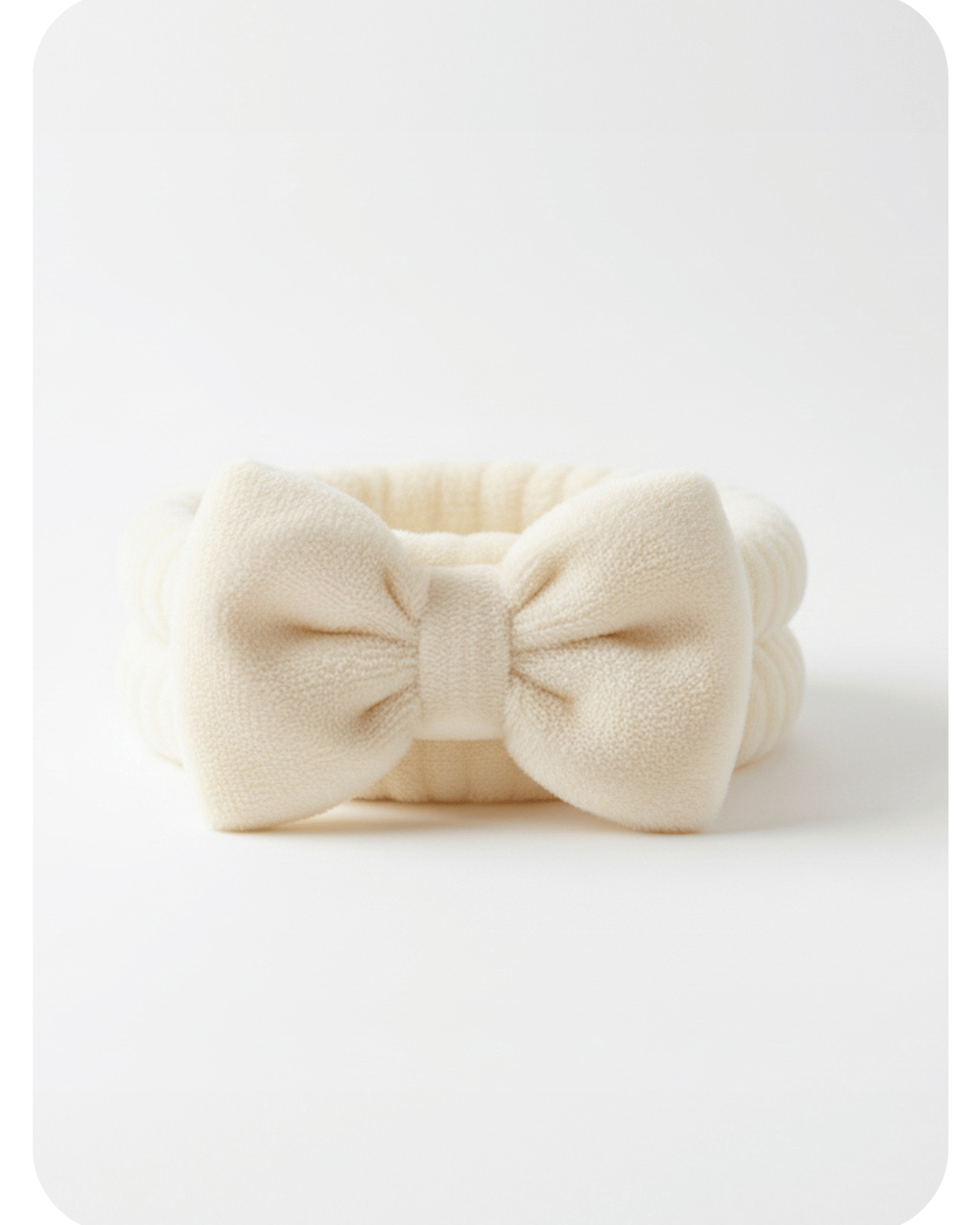 Cream-colored Dermaplane Prep Band headband with a bow on a white background