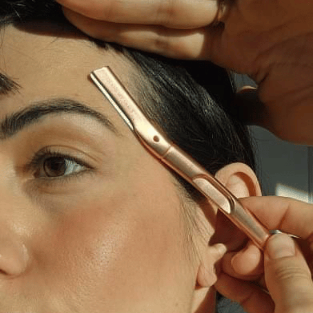 woman using a rose gold eyebrow facial razor for eyebrows as part of her dermaplaning bundle australia