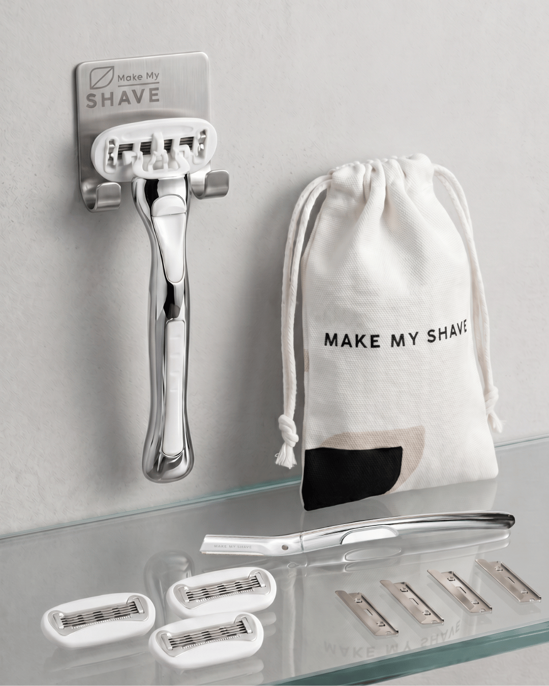 Metla dermaplaner and women's razor shave set with extra blades and drawstring bag on a grey surface.