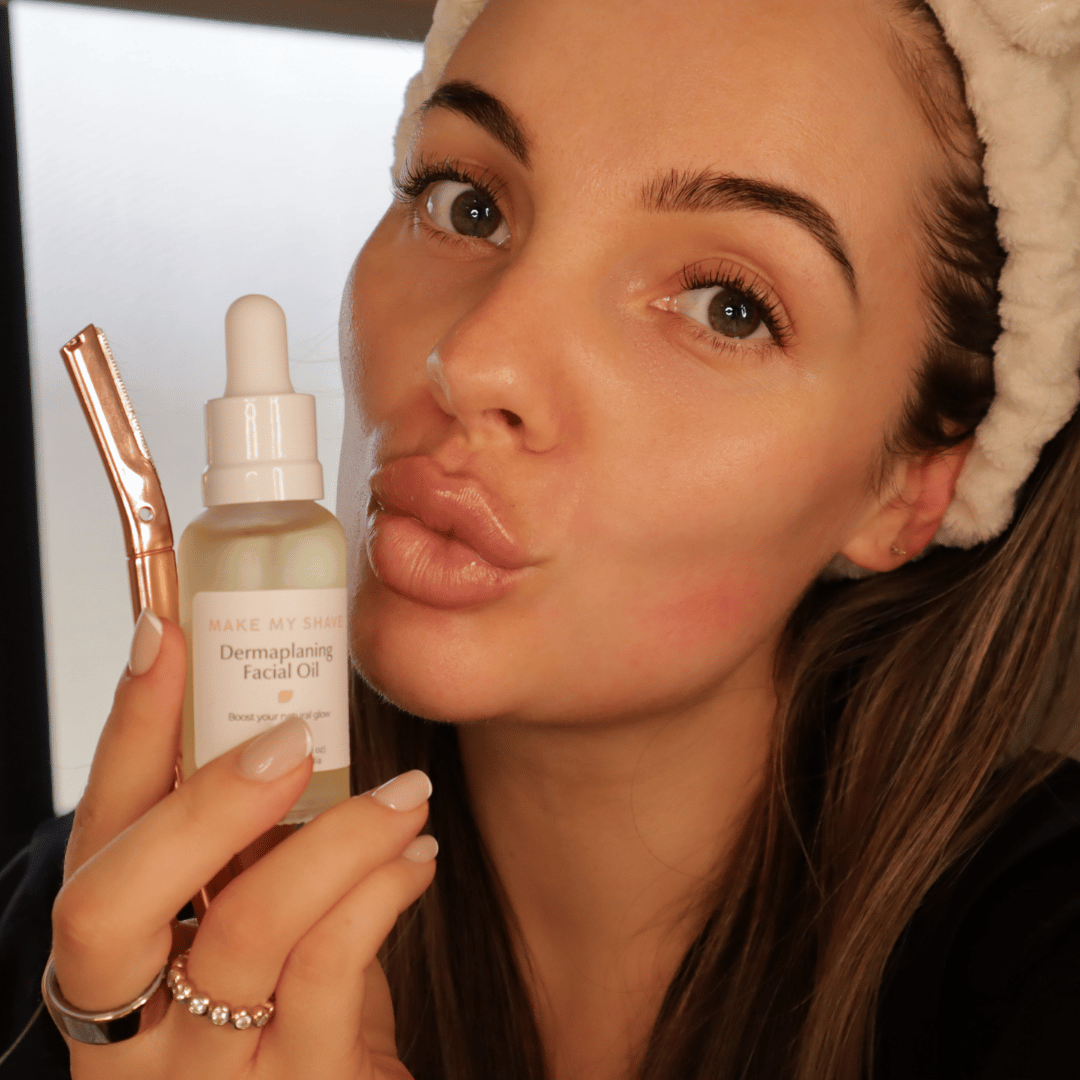 Woman holding the best dermaplaning tool and facial oil with blurred background
