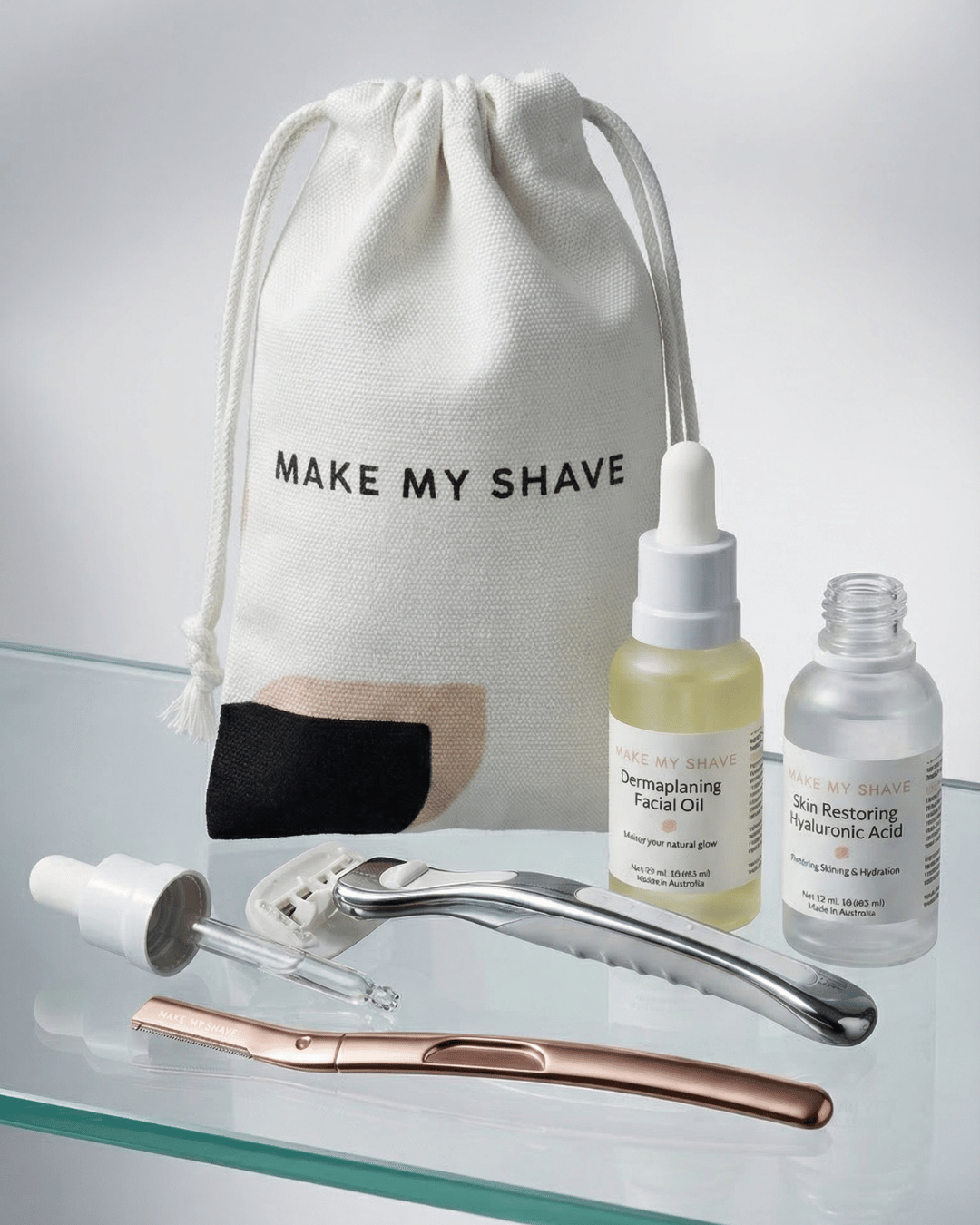 complete women's razor and dermaplaner bundle

Skincare products including a women's razor, dermaplaning facial oil, post-dermaplaning after care serum, a metal dermaplaning tool razor and a drawstring bag with the name 'MAKE MY SHAVE'.