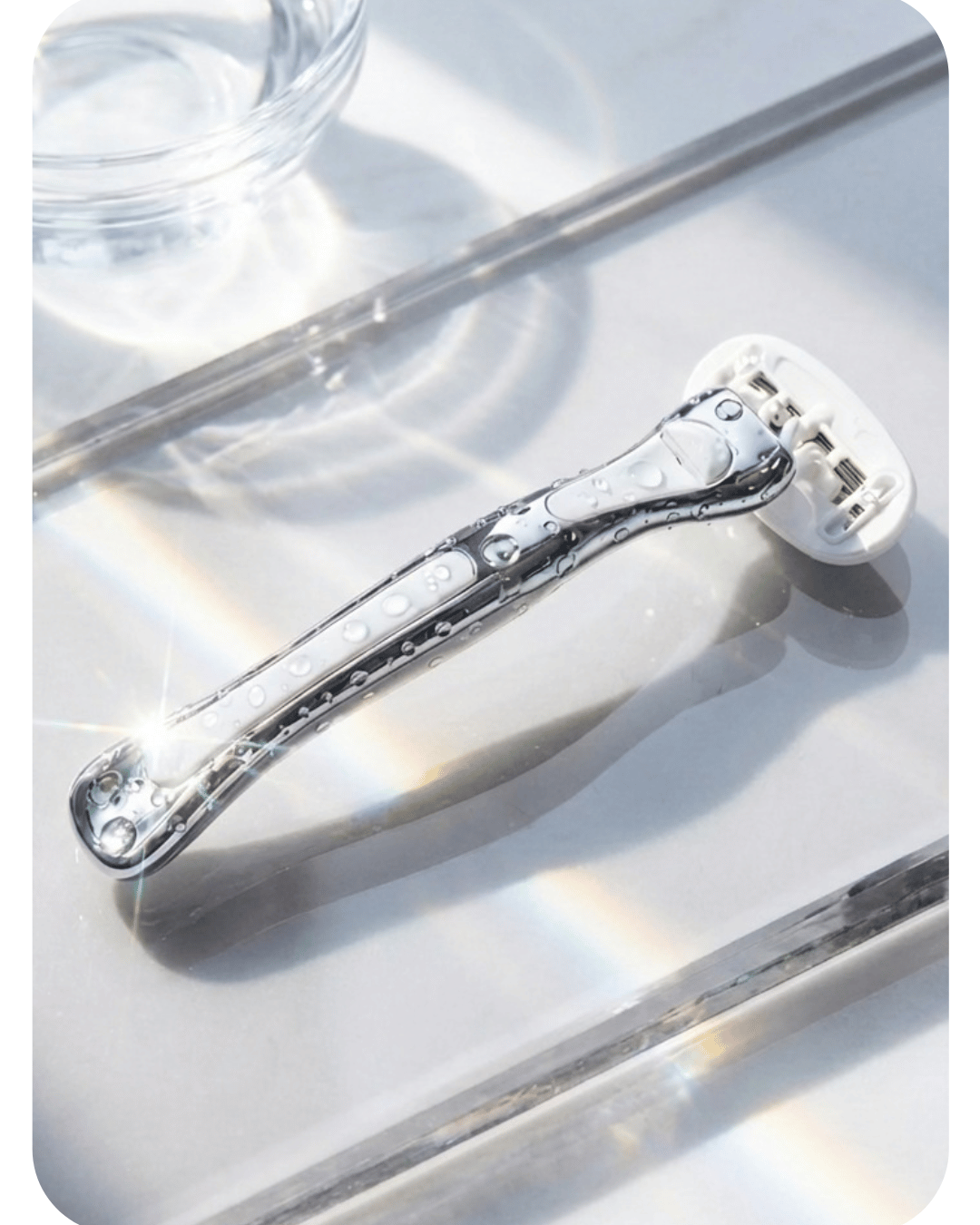 Reusable women's razor Australia on a glass shelf. Brand is Make My Shave. 